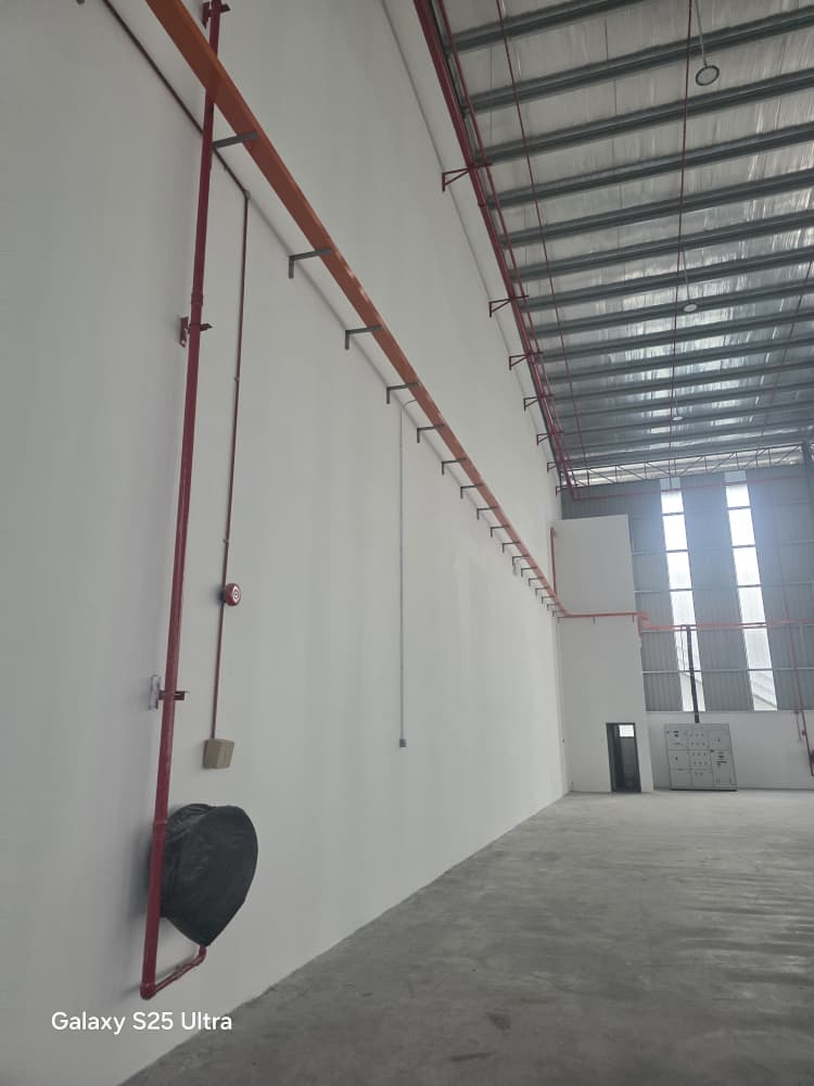 Factory interior showing tall walls and roof structure